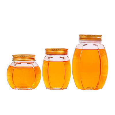 Contenitori di stoccaggio riciclabili dell'alimento del miele del coperchio del metallo del barattolo di forma di vetro di esagono fornitore