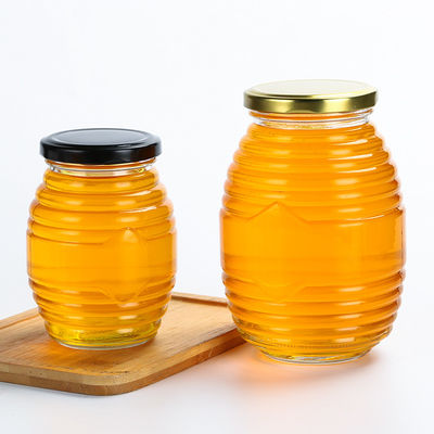La forma dell'ape pochi barattoli di vetro, immagina infilato intorno al barattolo di vetro con il coperchio fornitore