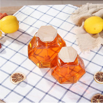 Vetro termoresistente Honey Jar di esagono del dispositivo di gocciolamento di legno fornitore