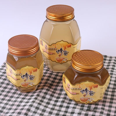 Contenitori di stoccaggio riciclabili dell'alimento del miele del coperchio del metallo del barattolo di forma di vetro di esagono fornitore